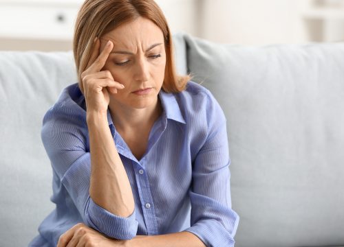 Woman experiencing dizziness and vertigo