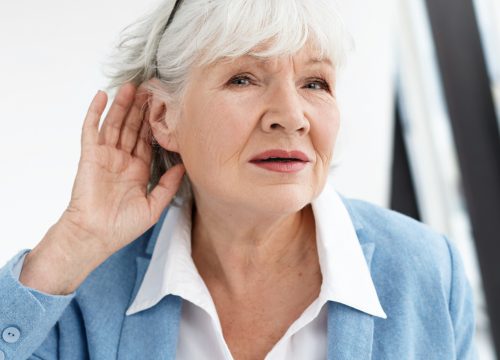 Older woman suffering from hearing loss
