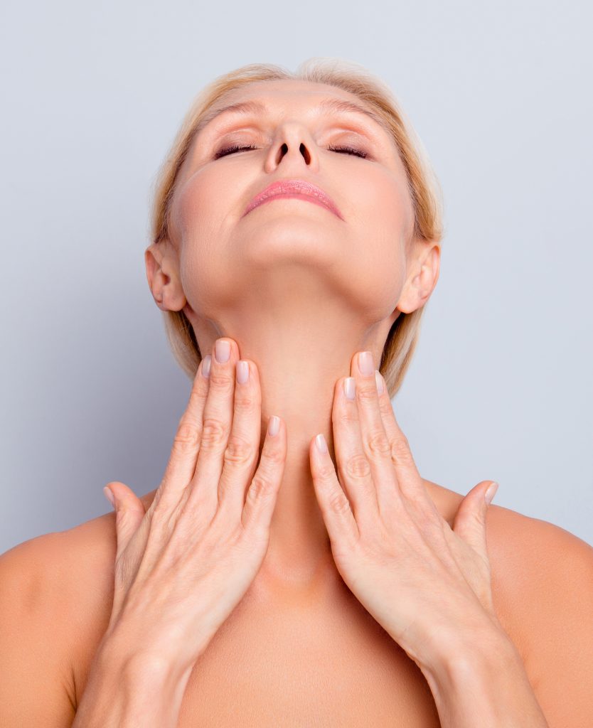 Woman pressing her hands against her neck