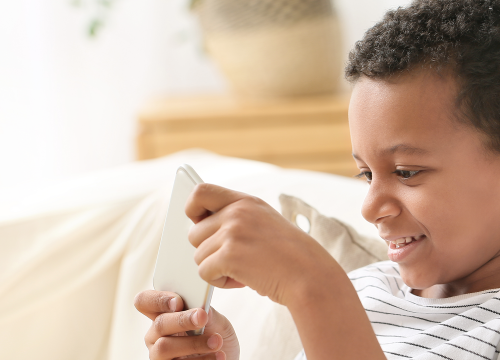 Child holding hearing aids