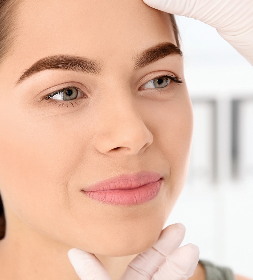 Closeup on a woman's face while she's being examined by a doctor.