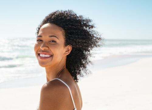 Photo of a smiling woman at the beach